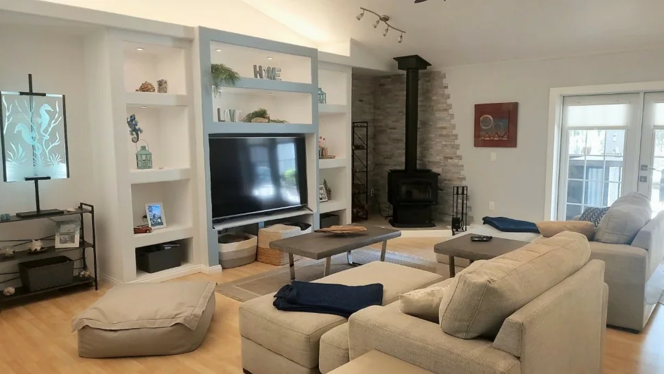 Living room with wood stove and built-in shelves